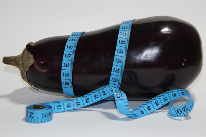 A tape measure wrapped around an eggplant